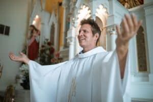 a priest praying inside the church