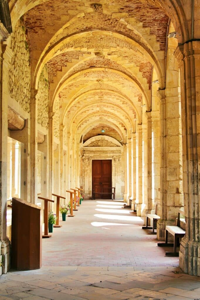 historic stone archway corridor with benches